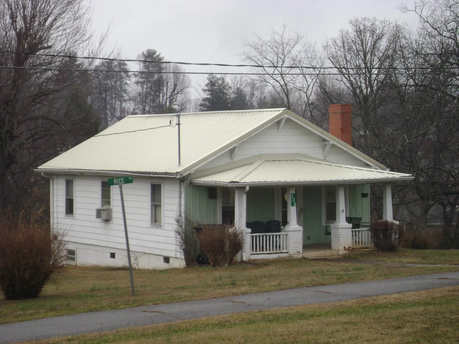 White metal roof on a craftsman bungalow at a street corner in Graysville